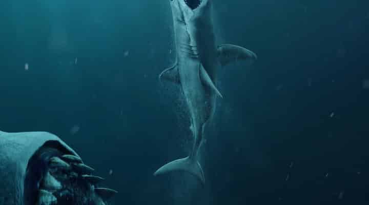A movie poster of The Meg featuring a shark about to eat another shark,, who is about to eat a man.