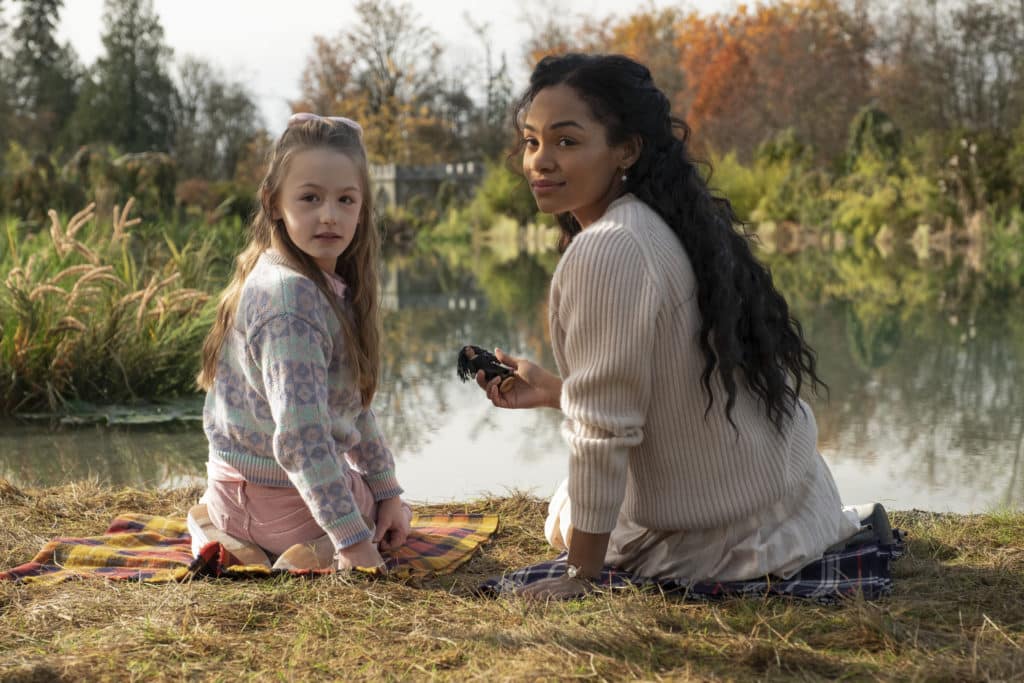 Flora and Ms. Jessel sitting by the lake