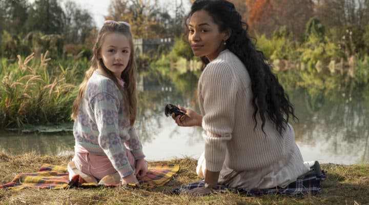 Flora and Ms. Jessel sitting by the lake